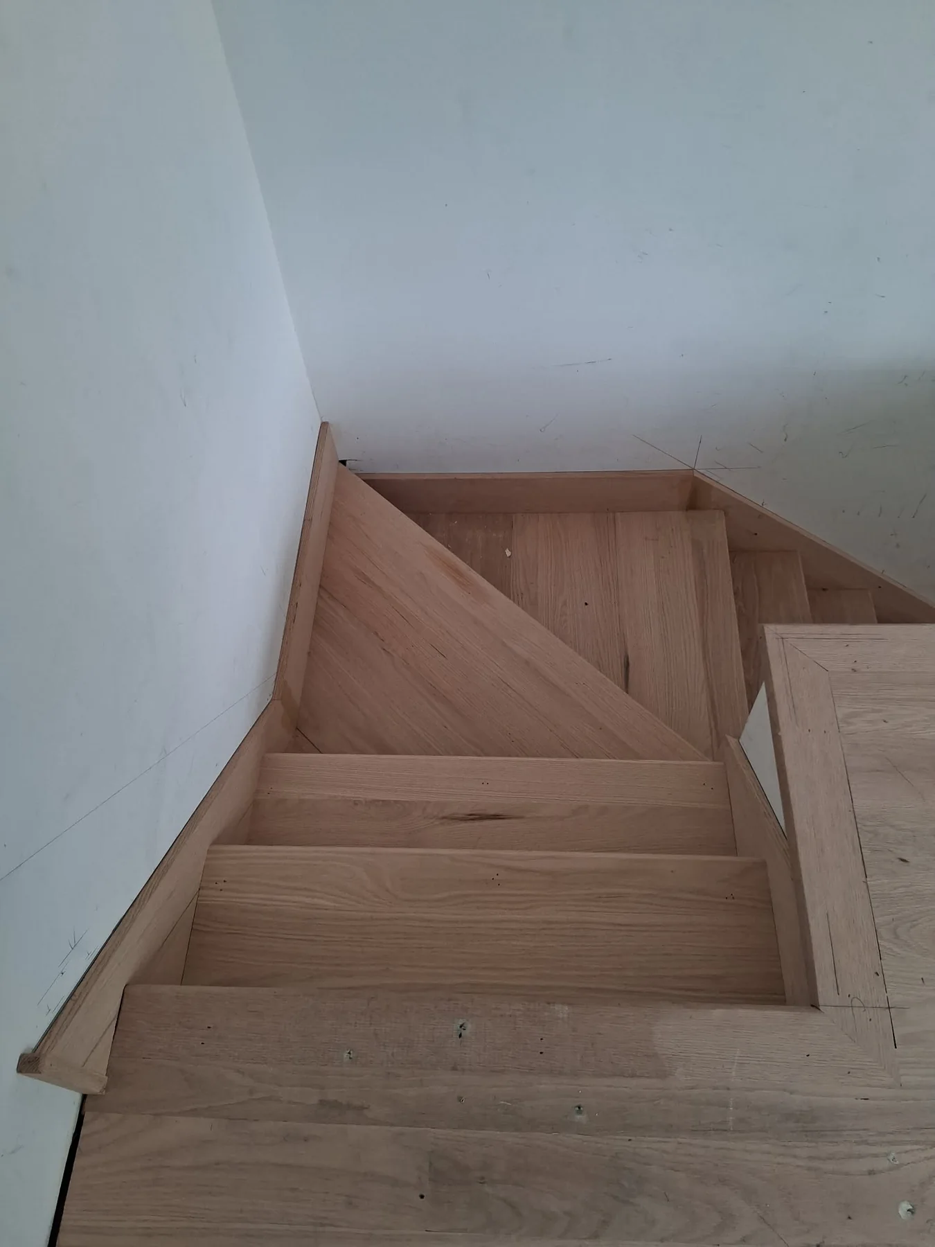 Hardwood staircase with custom angled landing